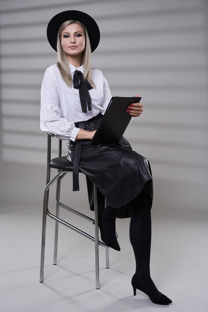 Business woman in black skirt and white shirt, full length studio portrait on gray background - Zdjęcie, obraz