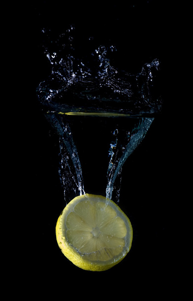 Slide of lemon splashing. - Zdjęcie, obraz