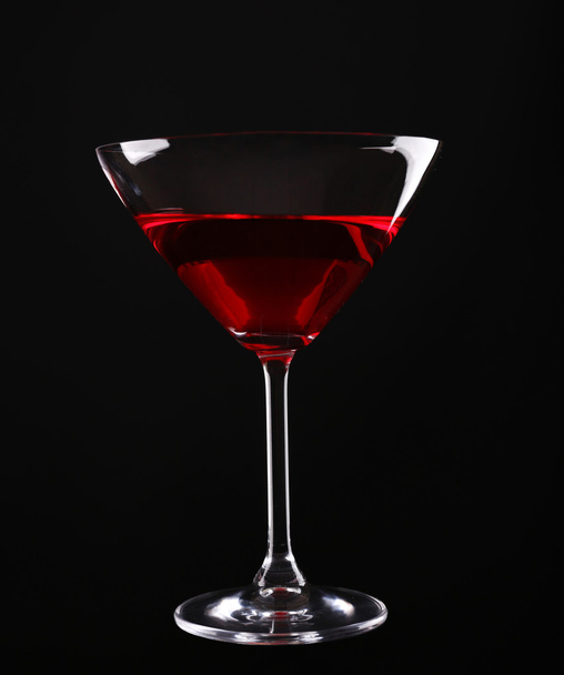 Colorful alcoholic beverage in glass on dark background - Photo, Image