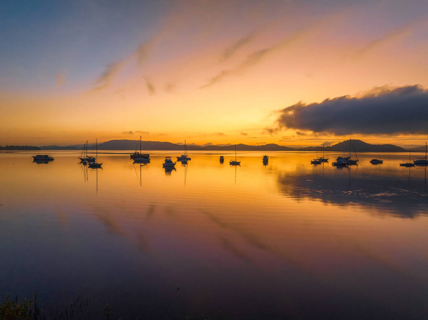 Soft and dreamy sunrise over Brisbane Water with clouds, fog and boats at Koolewong and Tascott on the Central Coast, NSW, Australia. - Fotó, kép