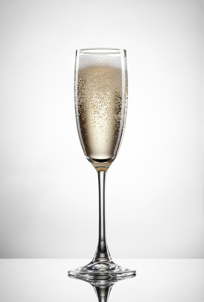 champagne in glass isolated on white - Фото, изображение