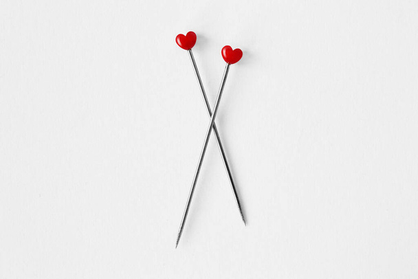 Two heart shaped pins on white background - Concept of love and relationship - Photo, Image