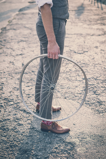 Man holding old bicycle wheel - Photo, Image