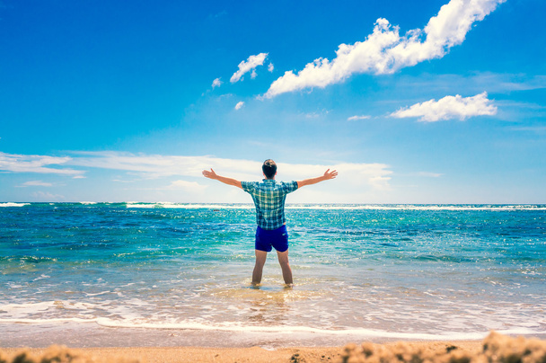 Man enjoying freedom  in water on the beach - Foto, Bild