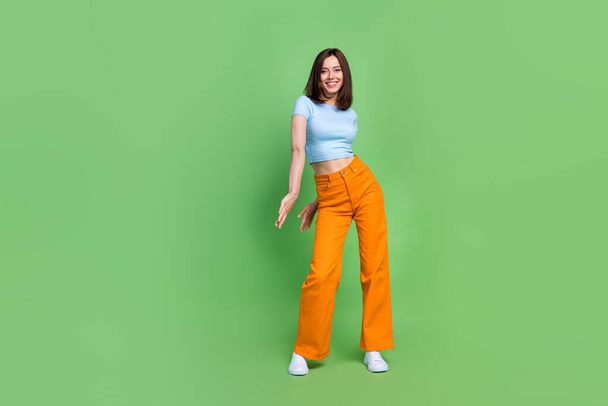 Full body photo of positive satisfied lady have good mood clubbing isolated on green color background. - Fotoğraf, Görsel