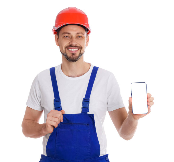 Professional repairman in uniform with phone on white background - Foto, Imagen