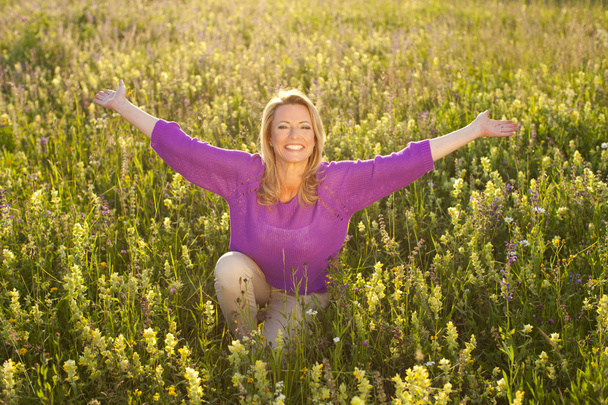 Happy woman in flower field - Фото, зображення