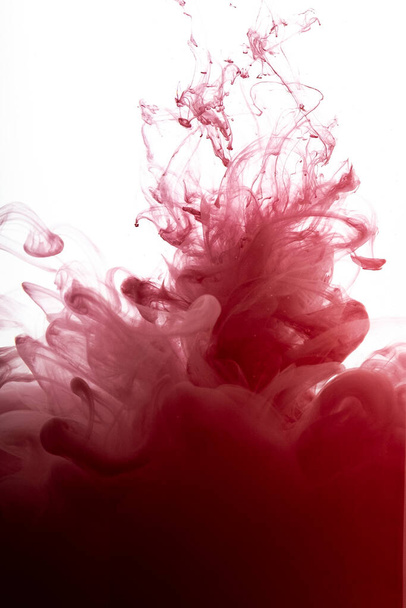Rote Farbe fließt in Rauchformen, glatte abstrakte Bewegung durch Acrylfarbe - Foto, Bild