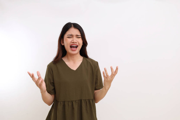 Stressed and frustrated young asian woman standing against white background with copyspace - Фото, зображення