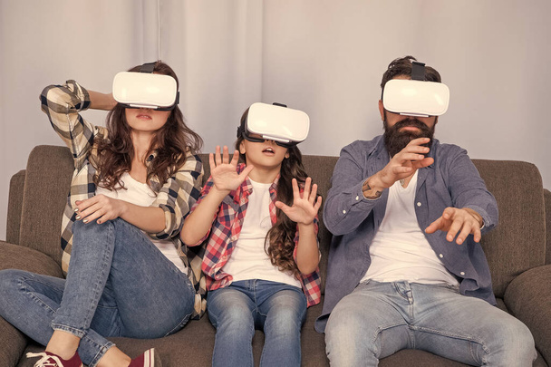 scared family wear vr glasses sitting on sofa at home, virtual reality. - Zdjęcie, obraz