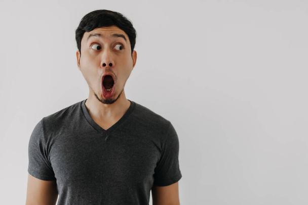 Funny amazing shocked surprised asian man face advertise isolated on white - Photo, Image