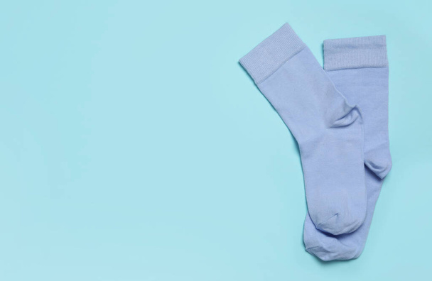 Pair of new socks on light blue background, top view. Space for text - Foto, Imagen