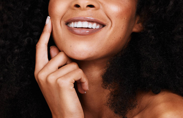 Black woman, smile and touch face with natural beauty, pride and confident with curly hair. Cosmetics, African American female and young lady with skincare, happy and organic facial with smooth skin. - Foto, immagini
