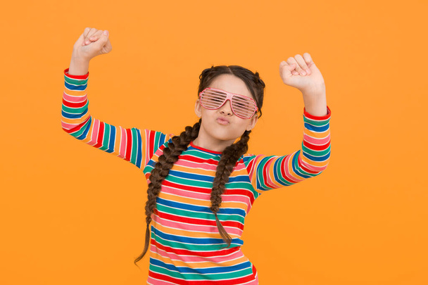 I can do this. funny kid having fun. beauty in glamour glasses. childhood happiness. smiling child on yellow background. casual fashion accessory. party time. happy teen girl with stylish hairstyle. - Фото, изображение