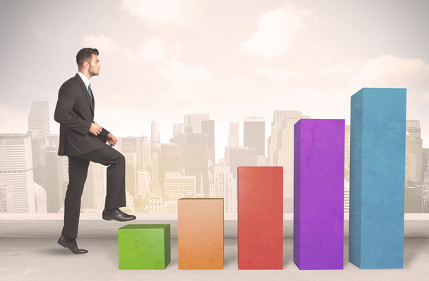 Business person climbing up on colourful chart pillars concept - Photo, Image