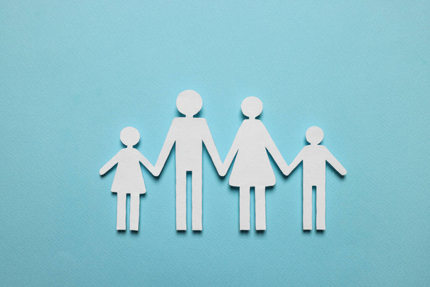 Paper family figures on light blue background, top view. Insurance concept - Foto, Bild
