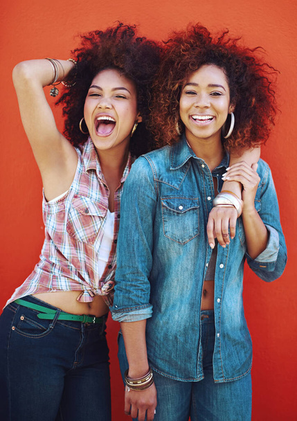 My bestie is crazy cool. two young friends posing against a red background - Foto, Imagen