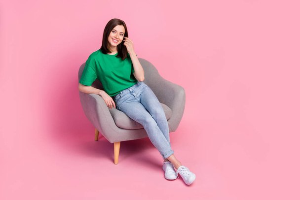 Full body photo of satisfied glad lady sitting chair hand touch hair isolated on pink color background. - Foto, imagen