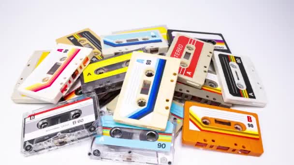 A piles of cassette tapes with different plain labels - Footage, Video