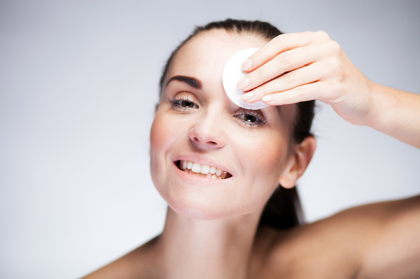 Fresh girl cleaning face with cotton swab - Foto, Imagen
