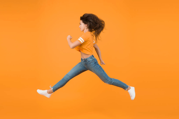 Energy rush. Energetic girl in motion yellow background. Sexy woman in energetic movement. Moving with haste in energetic mood. Casual fashion style. Young and energetic. Fast but graceful. - Φωτογραφία, εικόνα