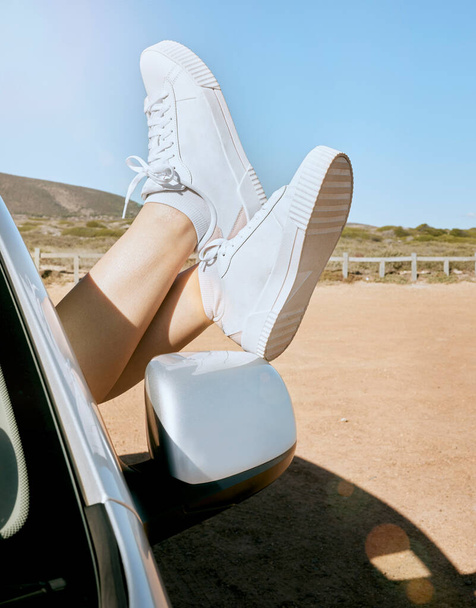 Relax, woman feet out of window and road trip in nature, enjoying freedom of travel in car on summer vacation. Blue sky, journey and shoes out of car window, adventure drive in African countryside - Φωτογραφία, εικόνα