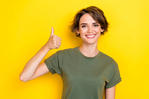 Close up photo of cheerful lady satisfied cool quality trendy clothes demonstrate symbol empty space isolated on yellow color background. - Fotó, kép