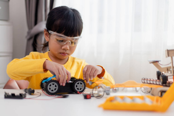 Asia students learn at home in coding robot cars and electronic board cables in STEM, STEAM, mathematics engineering science technology computer code in robotics for kids concept. - Φωτογραφία, εικόνα
