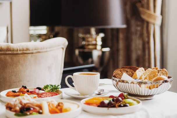 Luxury hotel and five star room service, various food platters, bread and coffee as in-room breakfast for travel and hospitality brand - Foto, Bild