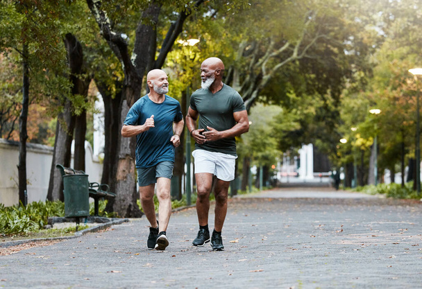 Mature, men and fitness with friends running in park for exercise, workout and wellness. Exercising, working out and diverse male athletic friend in cardio training for body health and stamina. - Foto, Imagen