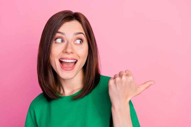 Photo portrait of excited young lady look direct empty space interesting news wear stylish green look isolated on pink color background. - Foto, immagini