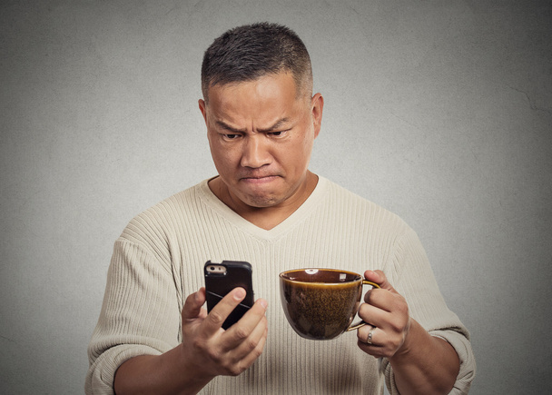 worried angry frustrated man reading bad news sms on smartphone - Valokuva, kuva