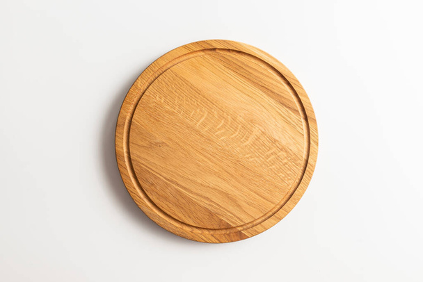 Empty wood round cutting board on white background. - Фото, изображение