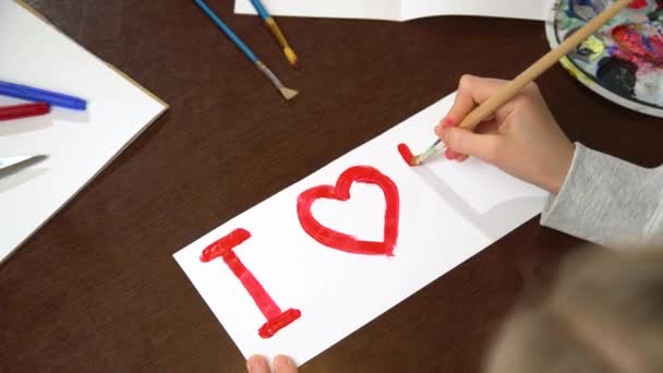 Hand painting I love you heart with red paint on white paper. Close up of creating Valentines greeting card.  - Footage, Video