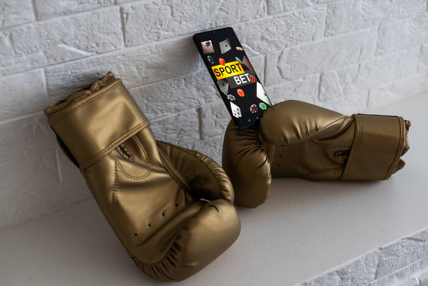 boxing gloves and smartphone with bets - Valokuva, kuva