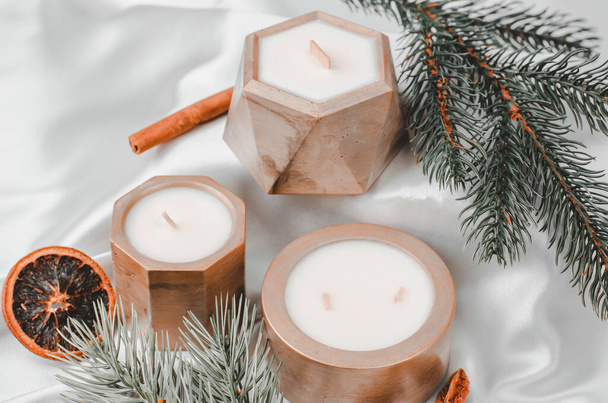 Candles in concrete pots and fir branches, festive composition, selective focus - Fotó, kép