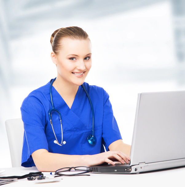 Young, professional and cheerful female doctor working in office - Φωτογραφία, εικόνα