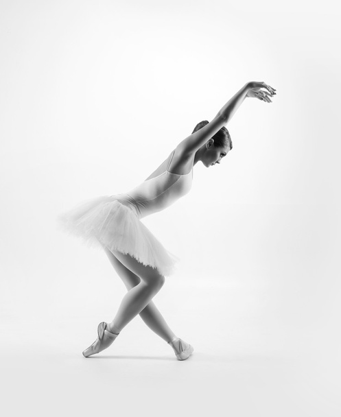 Young female ballet dancer performing a move - Fotó, kép