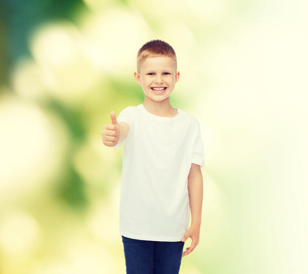 smiling boy in white t-shirt showing thumbs up - Fotó, kép