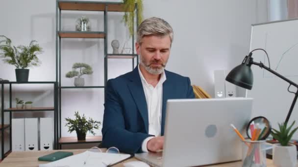 I choose you. Middle aged businessman programmer software developer working on office laptop pointing to camera, looking with happy expression, making choice, showing direction. Mature freelancer man - Footage, Video