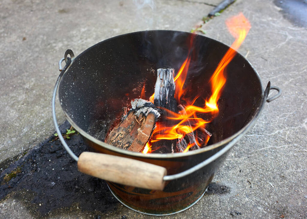 Do it yourself backyard BBQ grill in  a bucket with sausages and potatoes - Photo, Image