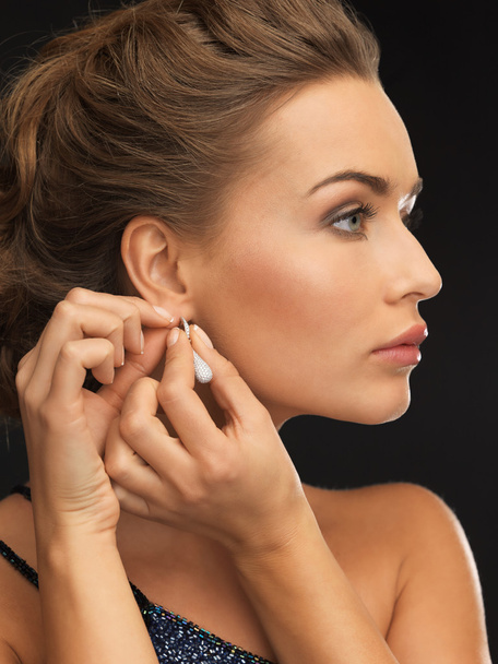 woman wearing shiny diamond earrings - Фото, зображення