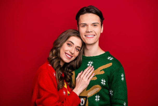 Photo of pretty cute couple wife husband hand touch chest heart spending time together magic season isolated on red color background. - Zdjęcie, obraz