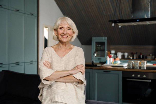 White senior woman smiling and looking at camera at home - Fotoğraf, Görsel