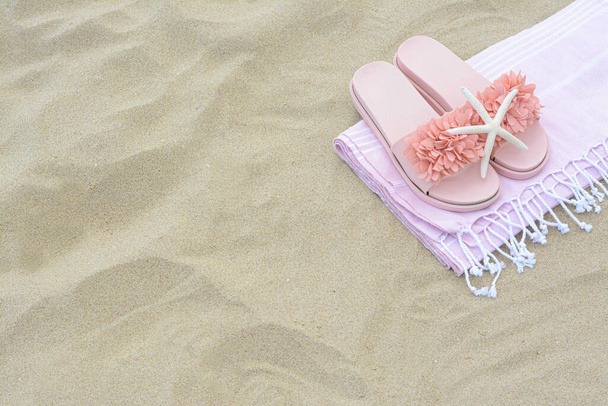 Blanket, stylish slippers and starfish on sand outdoors, above view with space for text. Beach accessories - Photo, Image