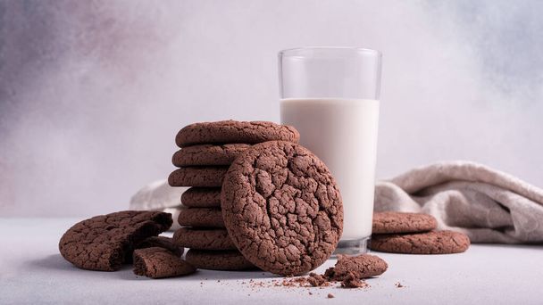 Homemade tasty american chocolate cookies with glass of milk on grey concrete background - Foto, immagini