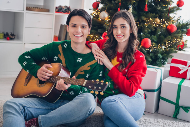 Photo of two idyllic partners cuddle play acoustic guitar enjoy christmastime harmony house indoors. - Foto, immagini