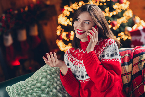 Photo of adorable attractive lady wear red sweater speak telephone make order prepare gift present enjoy winter magic time house indoors. - Photo, image