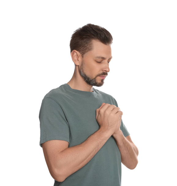Man with clasped hands praying on white background - Φωτογραφία, εικόνα