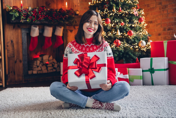 Photo of positive cheerful lady sit fluffy carpet hold santa claus gift enjoy cozy evening magic time season weekend room house indoors. - Foto, Bild